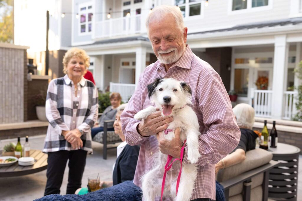 man holding his cute white dog