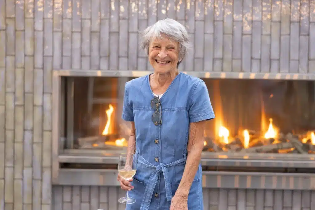 By the fireplace with wine glasses