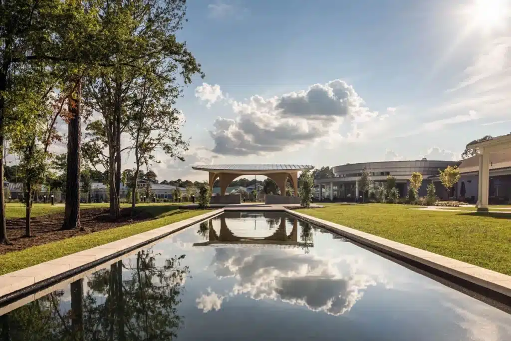Large water feature with a pergola at the end with a seating area
